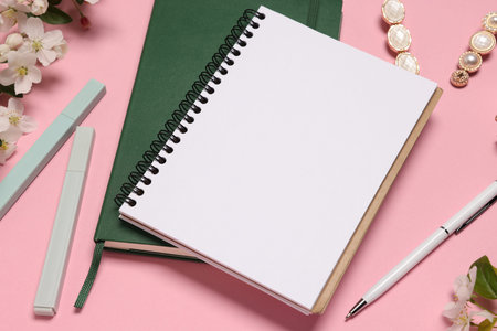 Planner and stationery on pink background, closeup