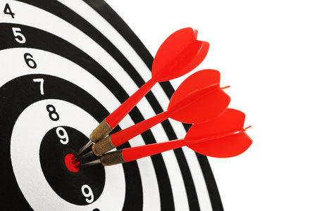 Targeting. Dart board with arrows isolated on white