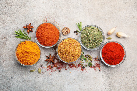 Different aromatic spices on light grey table, flat layの写真素材