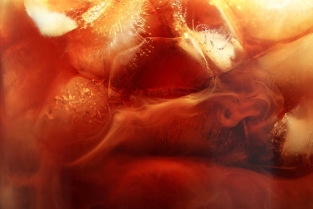 Refreshing coffee with ice and milk as background, closeupの写真素材