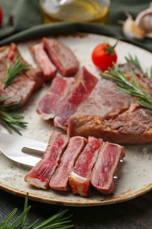 Pieces of delicious beef meat, spices and tomato on table, closeupの写真素材