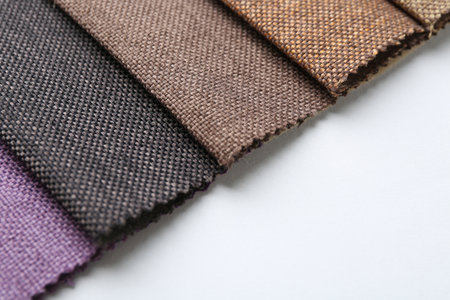 Samples of different fabrics on white background, closeup. Space for textの写真素材