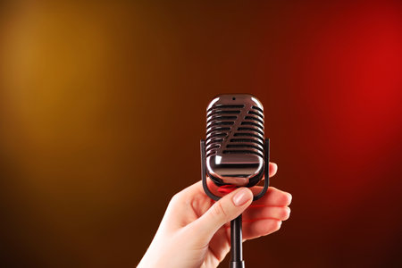 Woman with vintage microphone on color background, closeupの写真素材