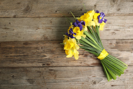 Bunch of beautiful flowers on wooden table, top view. Space for textの写真素材