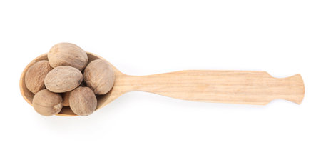 Nutmegs in wooden spoon isolated on white, top viewの写真素材