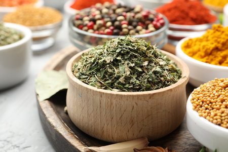 Different aromatic spices in bowls on grey table, closeupの写真素材