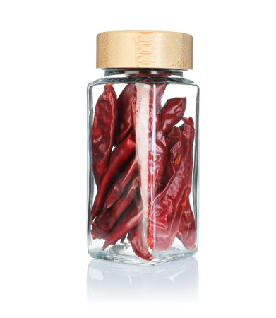 Red chili peppers in spice jar isolated on white