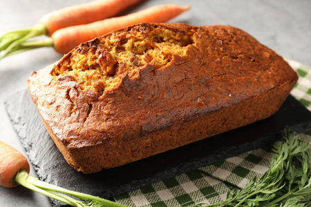 Tasty carrot cake on gray table, closeup
