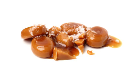 Tasty sweet candies, salt and caramel sauce isolated on whiteの写真素材