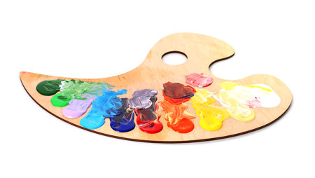 Wooden palette with paints isolated on whiteの写真素材