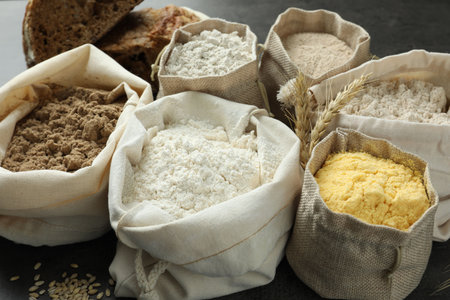 Different types of flour in bags on grey table, closeupの写真素材