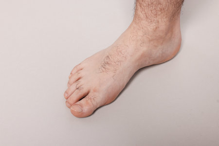 Barefoot man on light gray background, closeupの写真素材