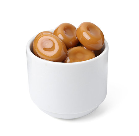 Tasty sweet caramel candies isolated on whiteの写真素材