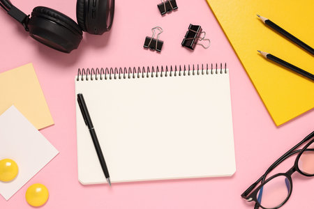 Planner and stationery on pink background, flat lay