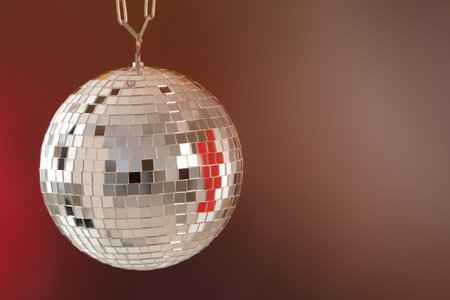 Shiny disco ball on color gradient background. Space for textの写真素材
