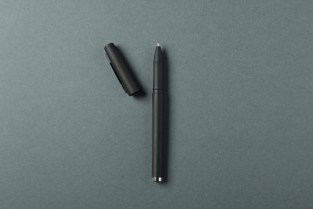 One stylish pen and lid on grey background, top viewの写真素材
