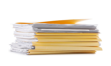 Stack of file folders with papers isolated on whiteの写真素材