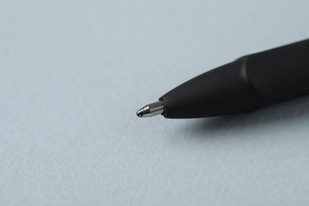 One ballpoint pen on grey background, macro view. Space for textの写真素材