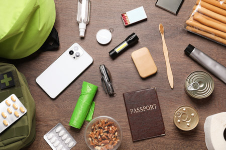 Survival kit. Different emergency supplies on wooden table, flat layの写真素材