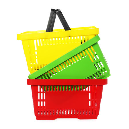 Stack of colorful shopping baskets isolated on whiteの写真素材