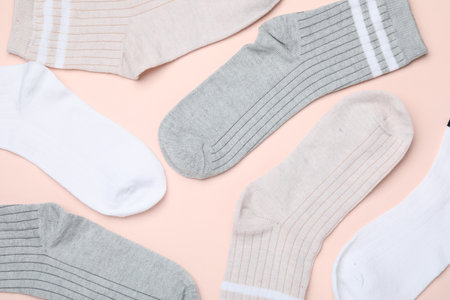 Many different pairs of socks on beige background, flat layの写真素材