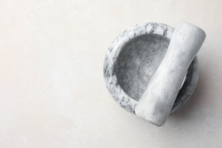 Marble mortar and pestle on white table, top view. Space for textの写真素材