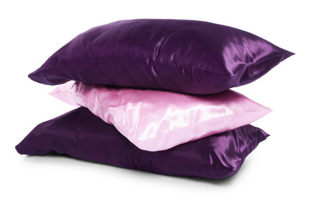 Pillows in pillowcases isolated on white. Silk bed linensの写真素材