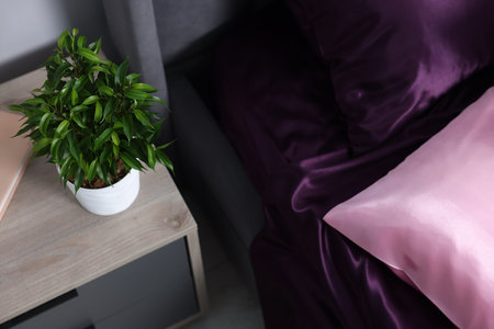 Luxury silk linens on bed and nightstand at homeの写真素材