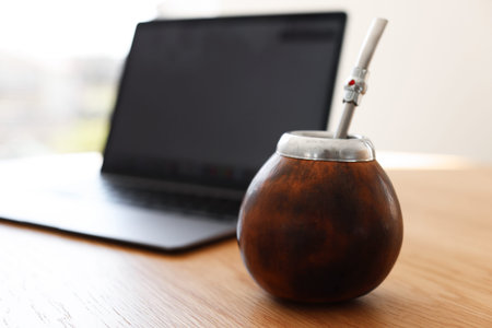 Traditional yerba mate tea on wooden table indoors, closeup