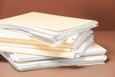 File folders with papers on brown background, closeupの写真素材