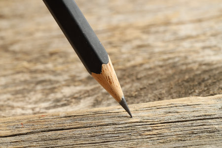 One sharp graphite pencil on wooden table, closeupの写真素材
