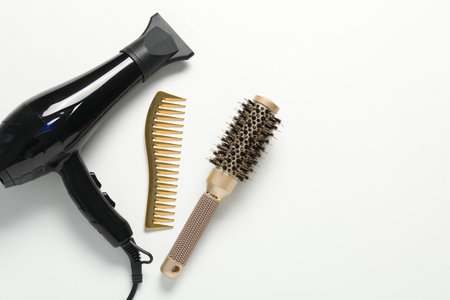 Different hairstyling tools on white background, flat lay. Space for textの写真素材