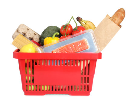 Shopping basket with different products isolated on whiteの写真素材