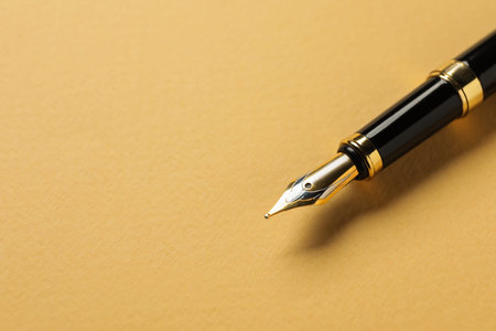 One fountain pen on yellow background, closeup. Space for text