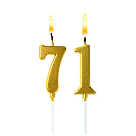 Burning golden cake candles composing number 71 on white background. Festive decoration for birthday or other special dateの写真素材
