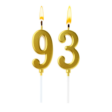Burning golden cake candles composing number 93 on white background. Festive decoration for birthday or other special dateの写真素材