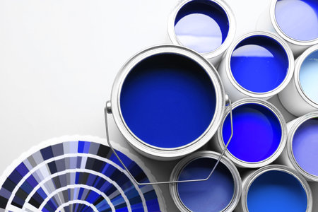 Cans with paint in shades of blue and color palette on white background, top viewの写真素材