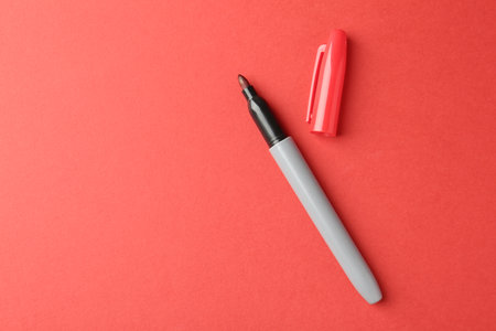 Two markers on red background, top view. Space for textの写真素材