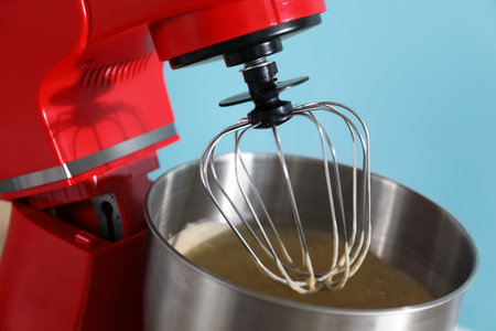 Stand mixer with dough on light blue background, closeupの写真素材