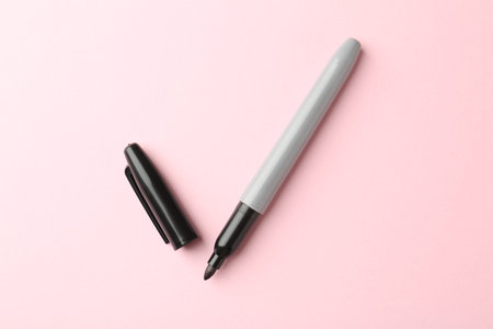 Two markers on light pink background, top view
