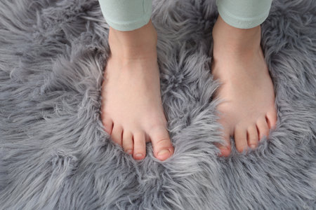 Girl on soft carpet at home, above viewの写真素材