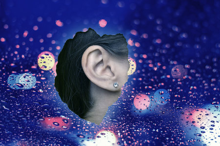 ASMR media (autonomous sensory meridian response). Woman's ear, view through wet glassの写真素材