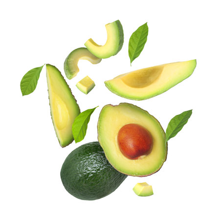 Fresh avocado fruits and leaves falling on white background