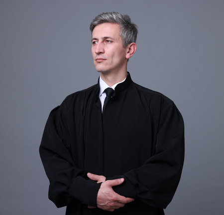 Portrait of judge in court dress on grey backgroundの写真素材