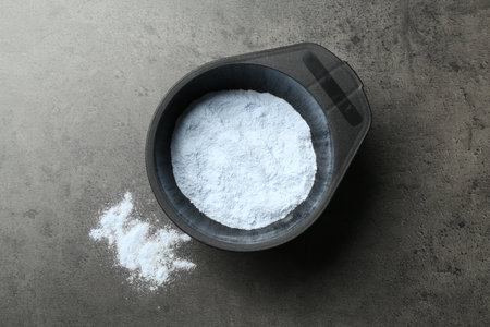Bowl with hair bleaching powder on grey table, top viewの写真素材