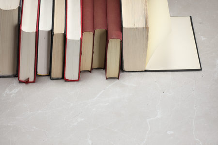 Different old books on light gray marble table. Space for textの写真素材