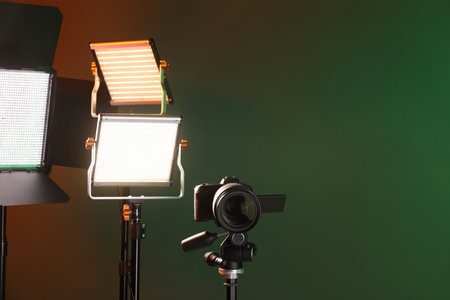 Professional lighting equipment and camera on color background. Space for textの写真素材
