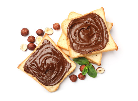 Toasts with chocolate hazelnut spread, nuts and mint isolated on white, top viewの写真素材