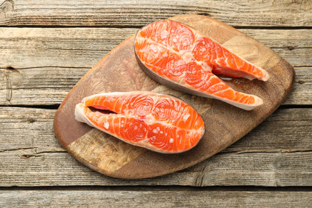 Seafood. Salmon steaks on wooden table, top viewの写真素材