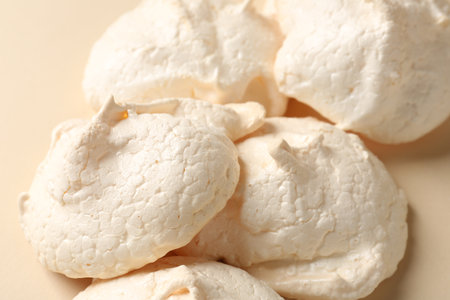 Delicious homemade meringue cookies on beige background, closeupの写真素材